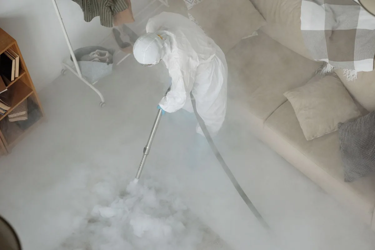 Biohazard cleanup technician in protective equipment, Glendale, CO